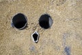 Abtract scene of three pipes in ciment forming a weird face