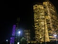 Abu Dhabi city business tower lights at night, UAE