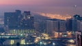 Abu Dhabi city skyline with skyscrapers before sunrise from above night to day Royalty Free Stock Photo