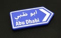 Abu Dhabi directional arrow on black.