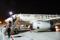 Abu Dhabi . November 2012. Airplane is on the platform at the glass jet bridge  at the Abu Dhabi  airport. Preparation for flight Royalty Free Stock Photo