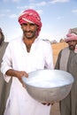 Man posing with a bowl of camel milk. Royalty Free Stock Photo