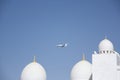 Abu- Dhabi UAE -March 03 2013:private jet flies over the domes of Sheikh Zayed Mosque Abu Dhabi UAE