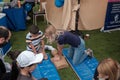 Abu Dhabi, UAE: Young female first-aider demonstrating CPR to kids with dummy kid