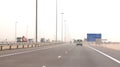 ABU DHABI, UNITED ARAB EMIRATES - APRIL 3rd, 2014: Trucks driving on a desert motorway in the United Arab Emirates with Royalty Free Stock Photo