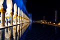 Abu Dhabi, United Arab Emirates - January 26, 2018: Crowded Sheikh Zayed Grand Mosque interior reflected in the surface at night Royalty Free Stock Photo