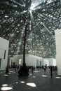 ABU DHABI, UNITED ARAB EMIRATES - JANUARY 26, 2018: Lights passing through roof and ceiling of Louvre Abu Dhabi presenting Rain o