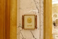 The golden coat of arms of UAE hangs on the wall in the ornate interior of the presidential palace - Qasr Al Watan in Abu Dhabi