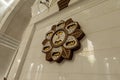 The splendor of large decorative clock showing prayer times in interior of Sheikh Zayed Grand Mosque in Abu Dhabi city, United