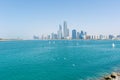 Abu Dhabi, United Arab Emirates skyline with a bright blue sky, sailboats, seagulls and landmark buildings in background. Luxury Royalty Free Stock Photo