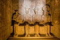 ABU SIMBEL, EGYPT - FEB 22, 2019: Statues of Ptah, Amun Ra, king Ramesses II and Ra-Horakhty illuminated by the rays of Royalty Free Stock Photo