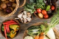 Abundance food bowls on wooden table. Onion, garlic, pepper, chili, paprika, zucchini, carrot, cabbage, tomato, potato