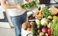 Abundance fruits and vegetables on wooden table in home kitchen Royalty Free Stock Photo