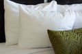 Abundant assortment of pillows adorns a beautifully made bed.