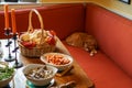 Abundant dinner table with cat sleeping in the corner Royalty Free Stock Photo