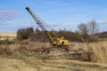 Abundant old, rusty mobile crane left on field.