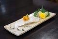 Aburi engawa sushi - Grilled flatfish (Fluke fin) on rice topping with fresh uni served with pickled ginge Royalty Free Stock Photo