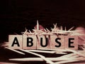 ABUSE text on wooden blocks in dark grungy background. Royalty Free Stock Photo