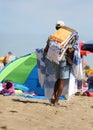 abusive itinerant seller on the sand while selling towels and be