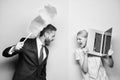 In abusive relationship. Businessman and housewife. Husband stand with dust brush while wife holding laptop. Family