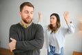 Abusive wife arguing husband, jealous distrustful dominant woman shouting at sad man