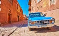 ABYANEH, IRAN - OCTOBER 23, 2017: The vintage blue car is parked in medieval street of historic mountain village, on October 23 in Royalty Free Stock Photo