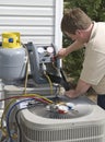 AC Repairman Charges Unit With Freon Royalty Free Stock Photo