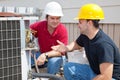 AC Technicians Discuss Problem Royalty Free Stock Photo