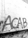 ACAB all cop are bastard written with red spray on a wall with highlighted pipe