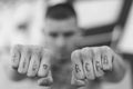 ACAB tattoo on the arm of a bully man. Black and white photo Royalty Free Stock Photo