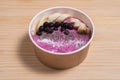 Acai berry smoothie in a wooden bowl topped with bananas, blueberries, raspberries and blackberries Royalty Free Stock Photo