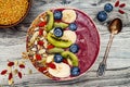 Acai breakfast superfoods smoothies bowl with chia seeds, bee pollen, goji berry toppings and fruits. Overhead. top view, flat lay