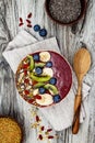 Acai breakfast superfoods smoothies bowl with chia seeds, bee pollen, goji berry toppings and fruits. Overhead. top view, flat lay Royalty Free Stock Photo