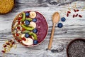 Acai breakfast superfoods smoothies bowl with chia seeds, bee pollen, goji berry toppings and fruits. Overhead. top view, flat lay Royalty Free Stock Photo