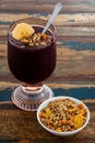 Acai in glass with muesli banana on wooden table