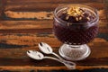 Acai in glass with muesli on wooden table Royalty Free Stock Photo