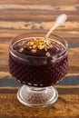 Acai in glass with muesli on wooden table. Vertical Royalty Free Stock Photo