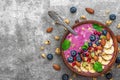 Acai smoothie bowl topped with banana, chia and pumpkin seed, blueberry, almonds and granola with spoon Royalty Free Stock Photo