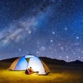 Camping tent in open field. Camp overnight. Camping tent with light on at night