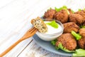 Acaraje or akara snack with green salad and sour cream