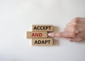 Accept or adapt symbol. Wooden blocks with words Accept and adapt. Beautiful white background. Businessman hand. Business and Royalty Free Stock Photo