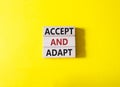 Accept or adapt symbol. Wooden blocks with words Accept and adapt. Beautiful yellow background. Business and Accept and adapt