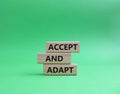 Accept or adapt symbol. Wooden blocks with words Accept and adapt. Beautiful green background. Business and Accept and adapt