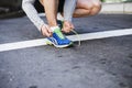 Accepting the challenge. Cropped image of a young man tying his laces before a run. Royalty Free Stock Photo