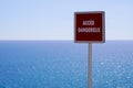 Acces dangereux text french panel sign means dangerous access on sea coast