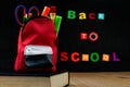 ACCESORIES IN STUDENT BAG WITH BLACK CHALK BOARD. BACK TO SCHOO Royalty Free Stock Photo