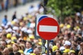 Access denied road sign with a large mass of people in the background - social or mass control Royalty Free Stock Photo