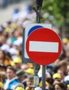 Access denied road sign with a large mass of people in the background - social or mass control Royalty Free Stock Photo