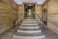 Access portal to the building with brown marble floors on the walls, stairs with golden metal railing and vintage elevator Royalty Free Stock Photo