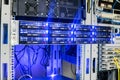 Access server close-up. Computer equipment with bright indication is installed in the rack of the server cabinet of the data